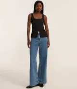 Musculosa marrón de poliéster texturizado, con escote cuadrado, breteles anchos, abotonado delantero y abertura inferior.