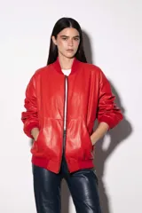 Campera bomber color amarillo pastel de cuero vacuno, con cierre delantero y bolsillos. Tiene puños, cuello y pretina de algodón.