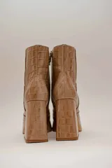 Botas de cuero color marrón con estampado croco, plataforma y taco cuadrado. Cierre lateral con cremallera.