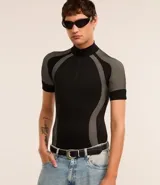 Remera negra ajustada al cuerpo, de cuello alto con cremallera y mangas cortas. Diseño seamless con estampa abstracta en tonos grises en hombros y laterales.