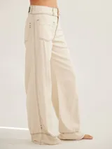 Pantalón negro de tiro medio alto, corte palazzo, con bolsillos delanteros y traseros.