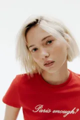 Remera roja de algodón con cuello redondo y estampado frontal con la frase "Paris enough?".