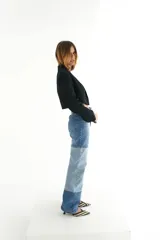 Pantalón de jean con diseño patchwork en diferentes tonos de azul, corte recto y tiro alto.