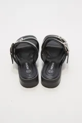 Sandalias negras con doble tira y hebillas plateadas.