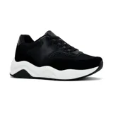Zapatillas deportivas negras con detalles en cuero sintético, gamuza y malla. Suela gruesa blanca con diseño ondulado.