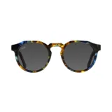 Lentes de sol redondos con montura de acetato multicolor con patrón de vetas en tonos azul, marrón y amarillo.