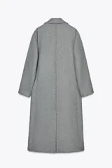 Abrigo gris de corte recto, largo hasta la rodilla, con cuello solapa, doble botonadura frontal y bolsillos con solapa.