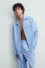 Pantalón de pijama celeste de algodón, corte relaxed fit, con cintura elástica ajustable con cordón interior, bolsillos laterales y detalle de vivos combinados a contraste en el bajo.