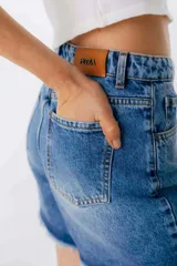 Short de jean color marrón con efecto desgastado, tiro alto y corte holgado.