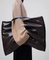 Maxi shopper acolchado de poliuretano color marrón oscuro, con asa de hombro y cierre magnético.