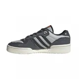 Zapatillas Adidas Rivalry Low de caña baja, color gris y negro, con detalles en cuero marrón y suela color crema.