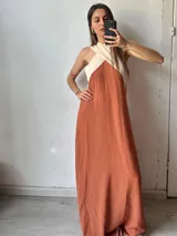 Vestido largo de color terracota con corte a la cintura y parte superior color crema con breteles cruzados.