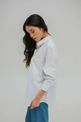 Camisa color crema de corte oversize y mangas largas.