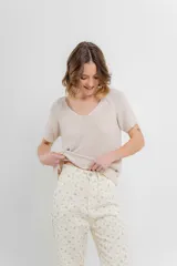 Remera tejida de manga corta, color gris claro, con escote en V y calce relajado. Presenta terminaciones acanaladas en mangas y ruedo.