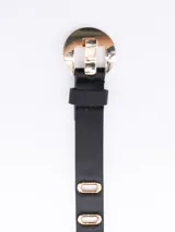 Cinto negro de cuero sintético con hebilla circular dorada y perforaciones con forma de letra 'O'.