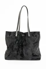 Bolso negro tipo tote bag confeccionado en gamuza vegana, con doble asa de hombro.