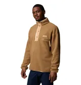 Buzo polar color marrón con cuello alto abotonado, bolsillo con cremallera en el pecho, puños y dobladillo elásticos.