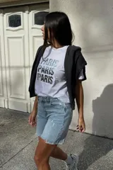 Remera blanca de algodón con la palabra 'Paris' estampada en plateado.