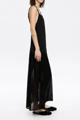 Vestido largo negro de punto con corte ajustado en la cadera y falda con vuelo, escote recto y tirantes dobles con aros metálicos y nudos.