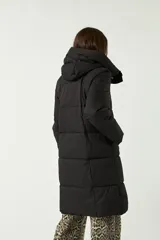 Campera negra larga acolchada con cierre frontal y cuello alto.
