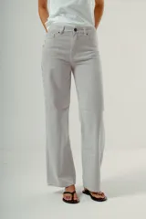 Pantalón de denim tiro alto, corte wide leg, color azul medio con estampado de pequeños lunares blancos.