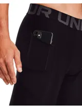 Calza deportiva Under Armour HG Armour Legging para hombre, color negro con cintura elástica gris con logo de la marca. Cuenta con tecnología HeatGear® para mantener la frescura y comodidad durante el entrenamiento.