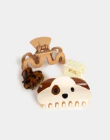 Set de cuatro broches para el pelo de diferentes formas y tamaños: broche con forma de perro, broche con estampado animal print, broche rectangular y broche con forma ondulada.