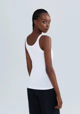 Musculosa slim color ocre, de tela acanalada con cuello redondo y sisas anchas.