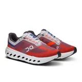 Championes de running On Cloudsurfer Next, color rojo y azul, con detalles en gris y blanco. Presentan tecnología CloudTec Phase para una amortiguación suave y reactiva.