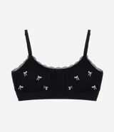 Soutien top negro de poliamida seamless texturizada con bordado de lazos blancos, breteles ajustables y copas removibles.