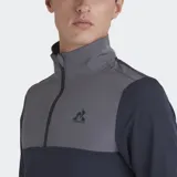 Buzo deportivo Le Coq Sportif de manga larga, con cuello alto y cierre parcial frontal. Presenta un diseño de bloques de color: la parte superior del pecho y el cuello son de color gris, mientras que el resto del cuerpo y las mangas son de color azul marino. Lleva el logo de la marca bordado en el pecho.