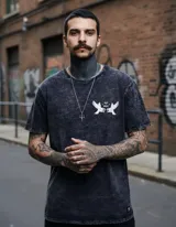 Remera negra con efecto lavado, corte clásico, cuello redondo y manga corta. Estampa en el pecho izquierdo con dos águilas enfrentadas y la leyenda "Pray I Mercy".