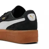 Championes Puma Palermo Elevata, color negro con franja blanca y suela marrón.