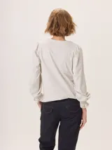 Pantalón de vestir color marrón, corte cigarette (pierna angosta) con tajo en el bajo. Presenta una cintura elástica ancha de color beige claro.