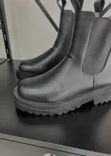 Botas cortas de cuero vegano color negro, con elástico lateral y suela track.