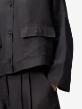 Sobrecamisa gris de lino y viscosa con cuello caja, manga japonesa, botonadura frontal y bolsillos de tapeta con botón.