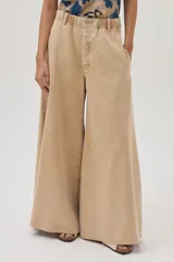 Pantalón jean de pierna ancha color beige, con cintura elastizada y bolsillos traseros cuadrados.