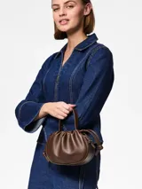 Cartera marrón de efecto cuero con asa superior y correa ajustable. Cierre magnético y bolsillo interior.