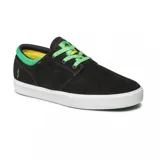 Zapatillas negras con detalles en verde, superficie de gamuza y suela blanca, diseñadas para skate.