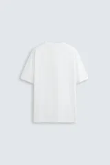 Remera color arena de corte recto, cuello redondo y mangas cortas.