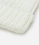 Gorro de lana color blanco con textura acanalada y pompón de pelo sintético en la parte superior.