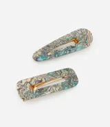 Set de dos pinzas para el pelo con efecto abulón en tonos beige, celeste y lila. El clip es dorado.