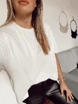 Remerón blanco de morley de algodón, manga corta, con dos pequeñas aberturas frontales y terminación en pico en la parte trasera.