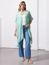 Kimono tejido color naranja con estampado abstracto en blanco y celeste, con terminación de ruedo con borlas.