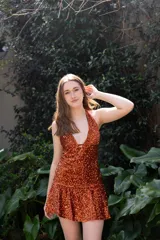 Vestido corto con lentejuelas color verde esmeralda, escote en V profundo y espalda descubierta.