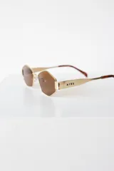 Lentes de sol con armazón y patillas metálicas plateadas, cristales oscuros con forma hexagonal facetada. La marca "AIRE" está grabada en la patilla derecha.