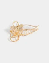 Broche dorado para el pelo con forma de moño y mariposa.