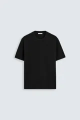 Camiseta negra de punto con corte relaxed fit, cuello redondo, manga corta y terminaciones en rib.