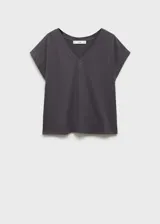 Camiseta gris con cuello en V, manga corta y detalle de tachuelas en los hombros.