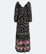 Vestido largo de viscosa negra con estampado floral en tonos rosa y verde. Tiene mangas largas abullonadas, escote en pico con detalle de puntilla y lazo frontal.